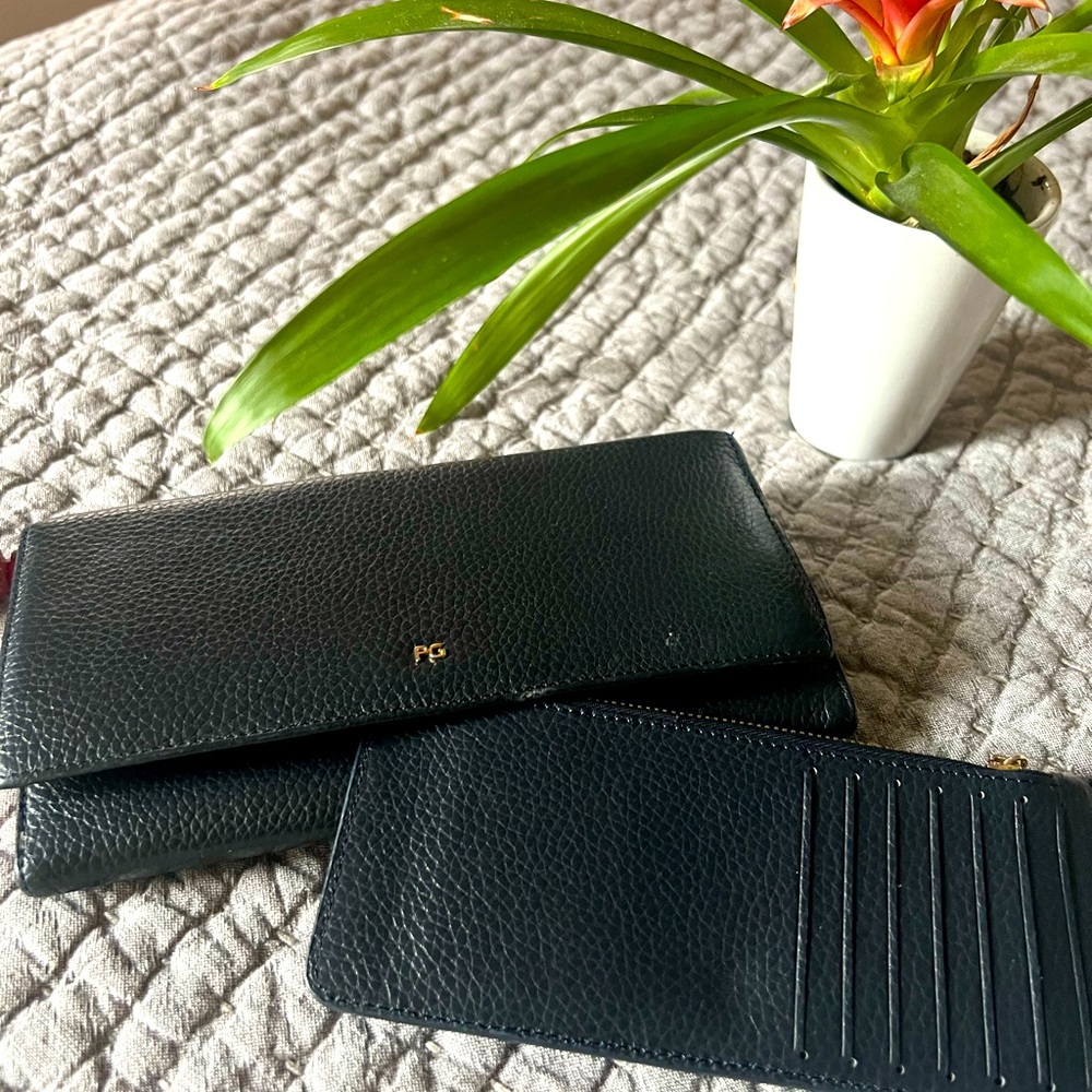 Leather wallet in dark blue with pink inside.